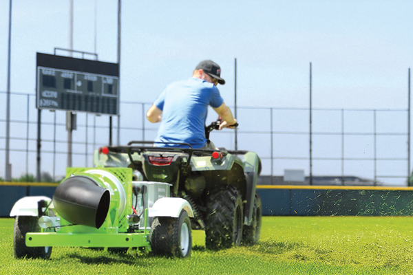 Cyclone EKB blower clearing grass on a sports field